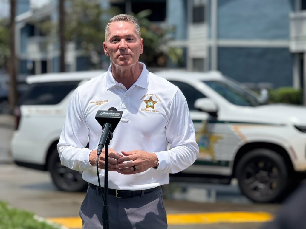 Sheriff Chad Chronister speaking at a podium outdoors.