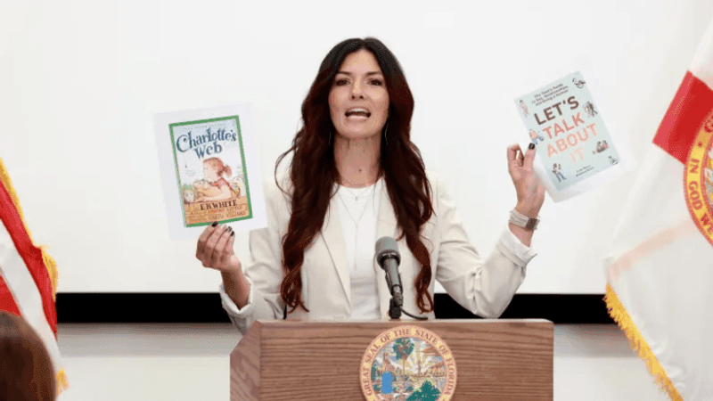 Orange County School Board Member Alicia Farrant holds up books during a 2024 news conference held by Florida Gov. Ron DeSantis in Orlando. Farrant, who was a member of the conservative Moms for Liberty group but chose not to highlight her involvement, lost her election last week to Angie Gallo. (Rich Pope, Orlando Sentinel)