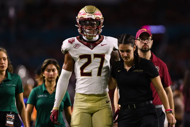 Oct 26, 2024; Miami Gardens, Florida, USA; Florida State Seminoles defensive back Ashlynd Barker (27) exits the field after an injury against the Miami Hurricanes during the fourth quarter at Hard Rock Stadium. Mandatory Credit: Sam Navarro-Imagn Images