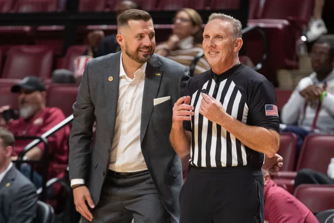Florida State Seminoles head coach Luke Loucks jokes with the referee. The Florida State Seminoles defeated the Alcorn State Braves 108-76 on Tuesday, Nov. 4, 2025.