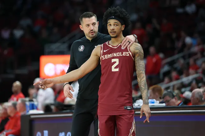 Dec 5, 2025; Houston, Texas, USA; Florida State Seminoles head coach Luke Loucks talks with guard Cam Miles (2) during the first half against the Houston Cougars at Toyota Center. Mandatory Credit: Troy Taormina-Imagn Images