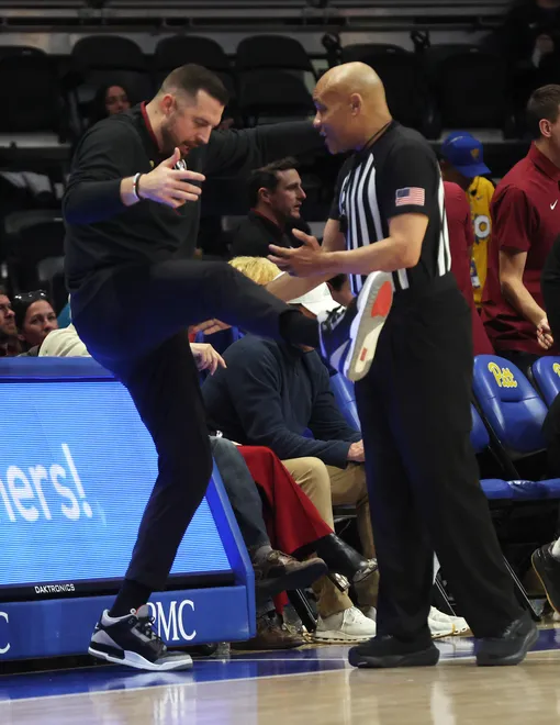 Mar 4, 2026; Pittsburgh, Pennsylvania, USA; Florida State Seminoles head coach Luke Loucks (left) asks for a kicked ball call to referee Bill Covington (right) against the Pittsburgh Panthers during the first half at the Petersen Events Center. Mandatory Credit: Charles LeClaire-Imagn Images