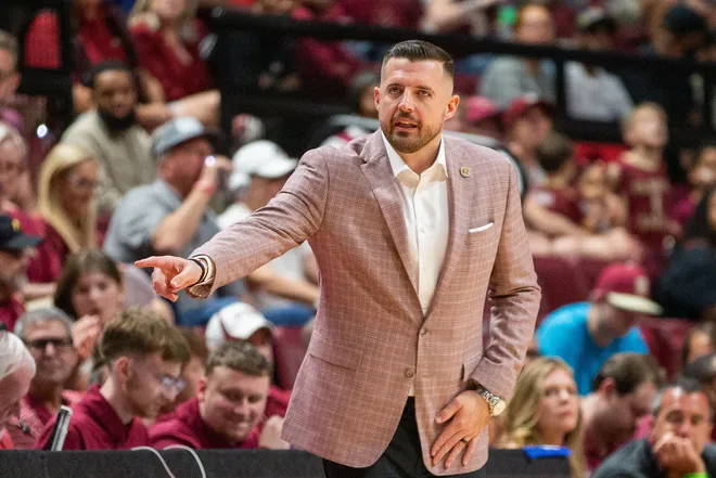Florida State Seminoles head coach Luke Loucks signals to a player from the sideline. The Florida State Seminoles hosted the Southern Methodist University Mustangs at the Tucker Civic Center on Saturday, March 7, 2026.