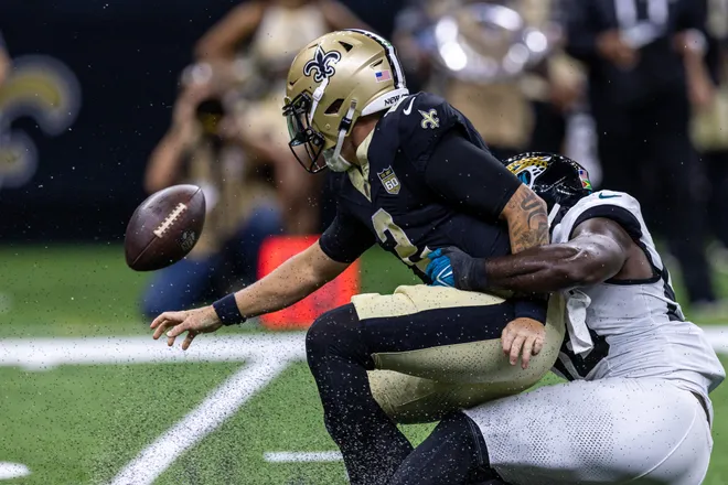 Aug 15, 2026; New Orleans, Louisiana, USA; New Orleans Saints quarterback Spencer Rattler (2) scrambles from the pocket and fumbles the ball against Jacksonville Jaguars linebacker Yasir Abdullah (56) during the first half at Caesars Superdome. Mandatory Credit: Stephen Lew-Imagn Images