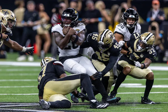 Aug 15, 2026; New Orleans, Louisiana, USA; Jacksonville Jaguars running back Deejay Dallas (20) is tackled by New Orleans Saints defensive end Myles Cole (57) and linebacker Deion Jones (45) during the second half at Caesars Superdome. Mandatory Credit: Stephen Lew-Imagn Images