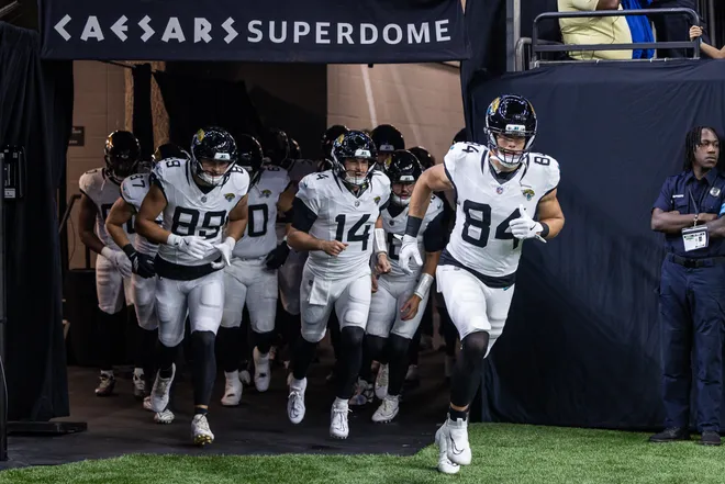 Aug 15, 2026; New Orleans, Louisiana, USA; Jacksonville Jaguars tight end Hunter Long (84) and quarterback Nick Mullens (14) run out the tunnel against the New Orleans Saints at Caesars Superdome. Mandatory Credit: Stephen Lew-Imagn Images