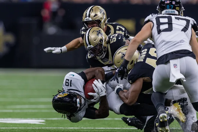 Aug 15, 2026; New Orleans, Louisiana, USA; New Orleans Saints linebacker Jaylan Ford (53) and linebacker Jackson Sirmon (47) tackle Jacksonville Jaguars wide receiver Josh Cameron (19) during the first half at Caesars Superdome. Mandatory Credit: Stephen Lew-Imagn Images