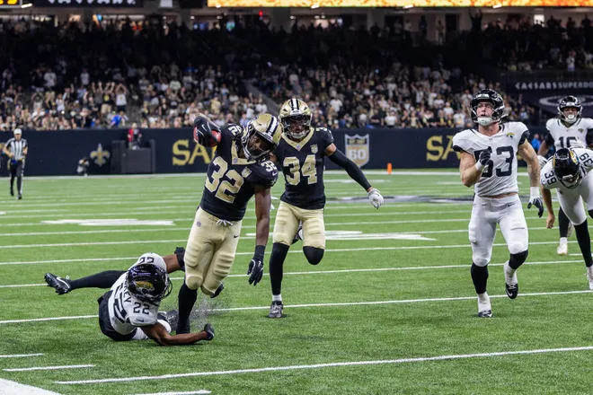 Aug 15, 2026; New Orleans, Louisiana, USA; New Orleans Saints running back Ty Chandler (32) runs the opening kickoff and is tackled by Jacksonville Jaguars safety Jalen Huskey (22) during the first half at Caesars Superdome. Mandatory Credit: Stephen Lew-Imagn Images