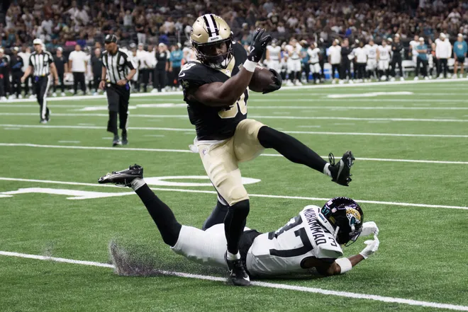 Aug 15, 2026; New Orleans, Louisiana, USA; New Orleans Saints running back Audric Estime (30) leaps over Jacksonville Jaguars defensive back Jabbar Muhammad (37) for a touchdown run during the first quarter at Caesars Superdome. Mandatory Credit: Matthew Hinton-Imagn Images