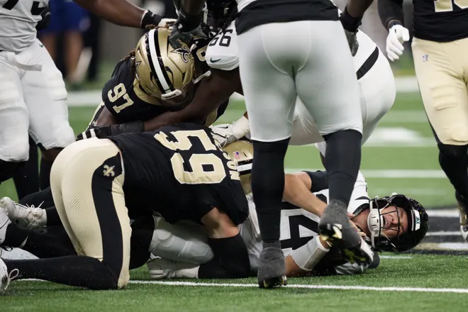 Aug 15, 2026; New Orleans, Louisiana, USA; Jacksonville Jaguars quarterback Nick Mullens (14) is sacked by New Orleans Saints defensive lineman Coziah Izzard (59) and defensive lineman Khristian Boyd (97) during the first quarter at Caesars Superdome. Mandatory Credit: Matthew Hinton-Imagn Images