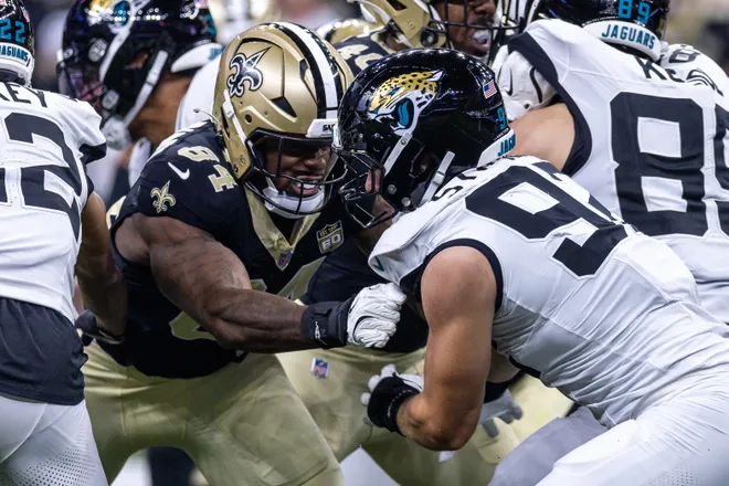 Aug 15, 2026; New Orleans, Louisiana, USA; New Orleans Saints tight end Zaire Mitchell-Paden (84) guards Jacksonville Jaguars defensive end Danny Striggow (92) on a field goal attempt during the first half at Caesars Superdome. Mandatory Credit: Stephen Lew-Imagn Images