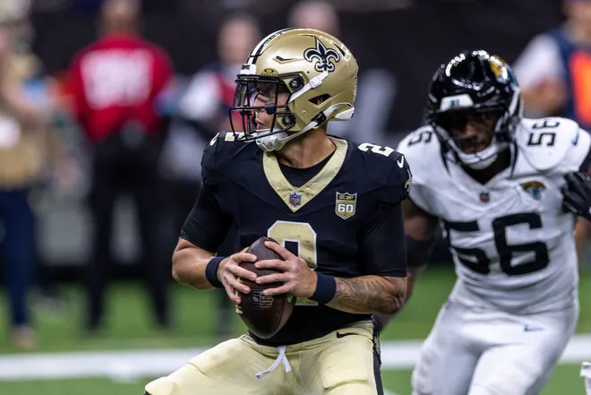 Aug 15, 2026; New Orleans, Louisiana, USA; New Orleans Saints quarterback Spencer Rattler (2) scrambles from the pocket and fumbles the ball against Jacksonville Jaguars linebacker Yasir Abdullah (56) during the first half at Caesars Superdome. Mandatory Credit: Stephen Lew-Imagn Images