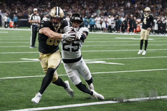 Aug 15, 2026; New Orleans, Louisiana, USA; New Orleans Saints tight end Oscar Delp (88) moves the ball across the goal line for a touchdown against Jacksonville Jaguars defensive back Rayuan Lane III (25) during the second quarter at Caesars Superdome. Mandatory Credit: Matthew Hinton-Imagn Images