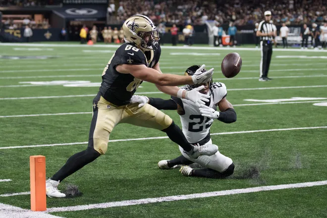 Aug 15, 2026; New Orleans, Louisiana, USA; New Orleans Saints tight end Oscar Delp (88) fumbles but had moved the ball across the goal line for a touchdown against Jacksonville Jaguars defensive back Rayuan Lane III (25) during the second quarter and the ball eventually ended up out of bounds at Caesars Superdome. Mandatory Credit: Matthew Hinton-Imagn Images