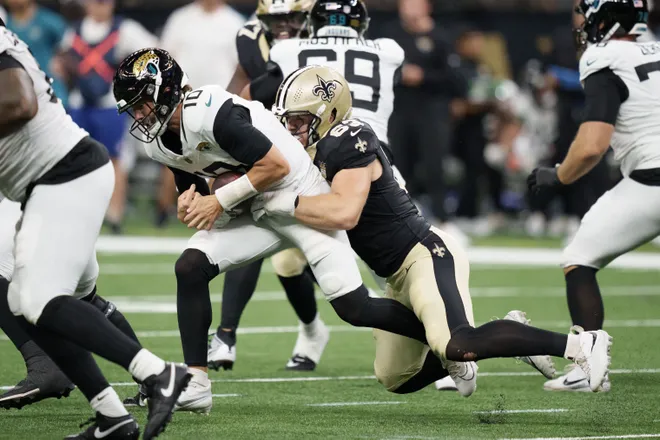Aug 15, 2026; New Orleans, Louisiana, USA; New Orleans Saints defensive lineman Michael Heldman (63) sacks Jacksonville Jaguars quarterback Carter Bradley (10) during the second quarter at Caesars Superdome. Mandatory Credit: Matthew Hinton-Imagn Images