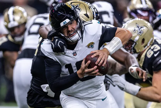 Aug 15, 2026; New Orleans, Louisiana, USA; Jacksonville Jaguars quarterback Carter Bradley (10) scramblers from the pocket and is sacked by New Orleans Saints defensive end Myles Cole (57) during the first half at Caesars Superdome. Mandatory Credit: Stephen Lew-Imagn Images
