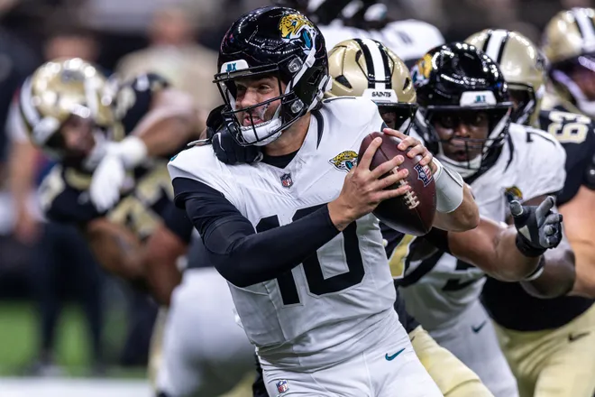 Aug 15, 2026; New Orleans, Louisiana, USA; Jacksonville Jaguars quarterback Carter Bradley (10) scramblers from the pocket and is sacked by New Orleans Saints defensive end Myles Cole (57) during the first half at Caesars Superdome. Mandatory Credit: Stephen Lew-Imagn Images