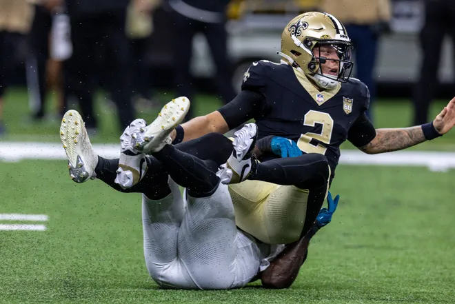 Aug 15, 2026; New Orleans, Louisiana, USA; New Orleans Saints quarterback Spencer Rattler (2) scrambles from the pocket and fumbles the ball against Jacksonville Jaguars linebacker Yasir Abdullah (56) during the first half at Caesars Superdome. Mandatory Credit: Stephen Lew-Imagn Images
