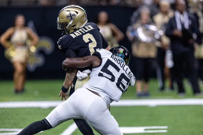 Aug 15, 2026; New Orleans, Louisiana, USA; New Orleans Saints quarterback Spencer Rattler (2) scrambles from the pocket and fumbles the ball against Jacksonville Jaguars linebacker Yasir Abdullah (56) during the first half at Caesars Superdome. Mandatory Credit: Stephen Lew-Imagn Images