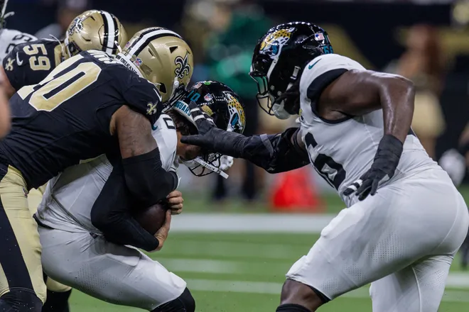 Aug 15, 2026; New Orleans, Louisiana, USA; Jacksonville Jaguars quarterback Carter Bradley (10) scrambles out of the pocket and is sacked by New Orleans Saints defensive end Fadil Diggs (40) during the second half at Caesars Superdome. Mandatory Credit: Stephen Lew-Imagn Images