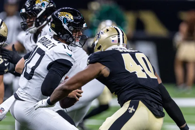 Aug 15, 2026; New Orleans, Louisiana, USA; Jacksonville Jaguars quarterback Carter Bradley (10) scrambles out of the pocket and is sacked by New Orleans Saints defensive end Fadil Diggs (40) during the second half at Caesars Superdome. Mandatory Credit: Stephen Lew-Imagn Images