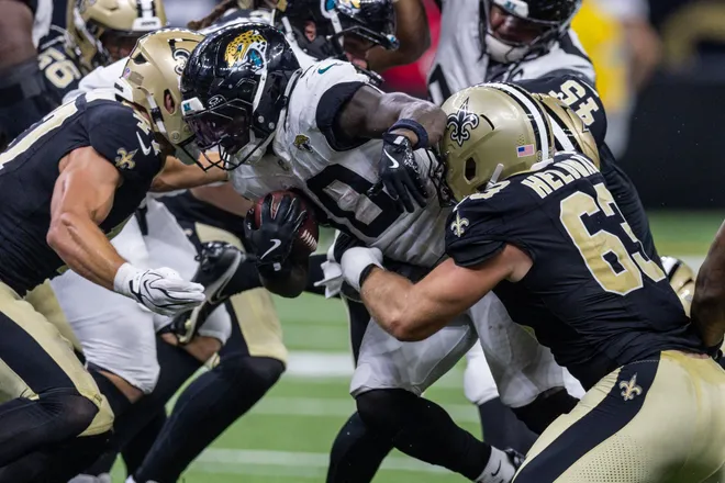 Aug 15, 2026; New Orleans, Louisiana, USA; Jacksonville Jaguars running back J'mari Taylor (30) is tackled by New Orleans Saints defensive end Michael Heldman (63) during the second half at Caesars Superdome. Mandatory Credit: Stephen Lew-Imagn Images