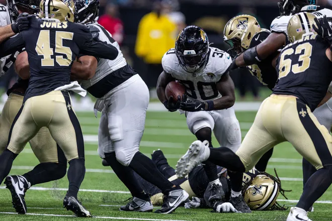 Aug 15, 2026; New Orleans, Louisiana, USA; Jacksonville Jaguars running back J'mari Taylor (30) runs against New Orleans Saints linebacker Deion Jones (45) and defensive end Michael Heldman (63) during the second half at Caesars Superdome. Mandatory Credit: Stephen Lew-Imagn Images