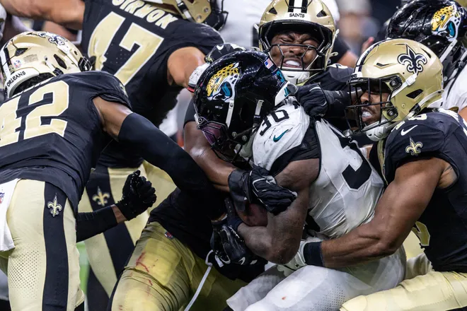 Aug 15, 2026; New Orleans, Louisiana, USA; Jacksonville Jaguars running back J'mari Taylor (30) is tackled by New Orleans Saints cornerback Mike Reid (42) during the second half at Caesars Superdome. Mandatory Credit: Stephen Lew-Imagn Images