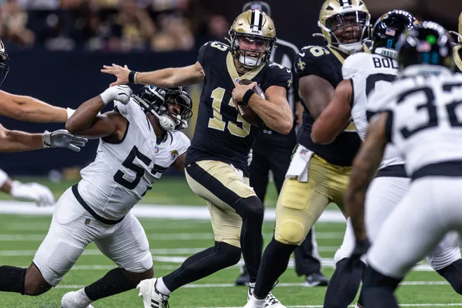 Aug 15, 2026; New Orleans, Louisiana, USA; New Orleans Saints quarterback Hunter Dekkers (13) runs against Jacksonville Jaguars defensive end Bryan Thomas Jr. (57) during the second half at Caesars Superdome. Mandatory Credit: Stephen Lew-Imagn Images