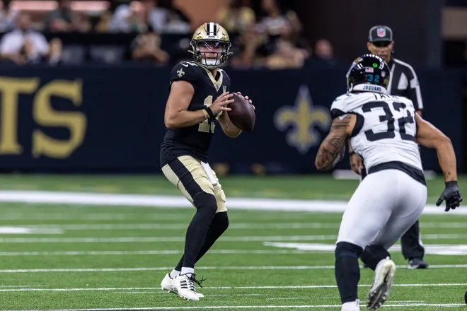 Aug 15, 2026; New Orleans, Louisiana, USA; New Orleans Saints quarterback Hunter Dekkers (13) passes against Jacksonville Jaguars linebacker Jahlani Tavai (32) during the second half at Caesars Superdome. Mandatory Credit: Stephen Lew-Imagn Images
