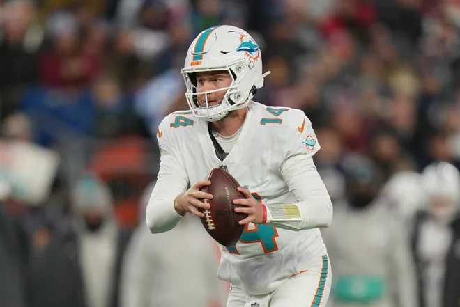 Jan 4, 2026; Foxborough, Massachusetts, USA; Miami Dolphins quarterback Quinn Ewers (14) looks to hand the ball off to a teammate against the New England Patriots during the first quarter at Gillette Stadium. Mandatory Credit: David Butler II-Imagn Images