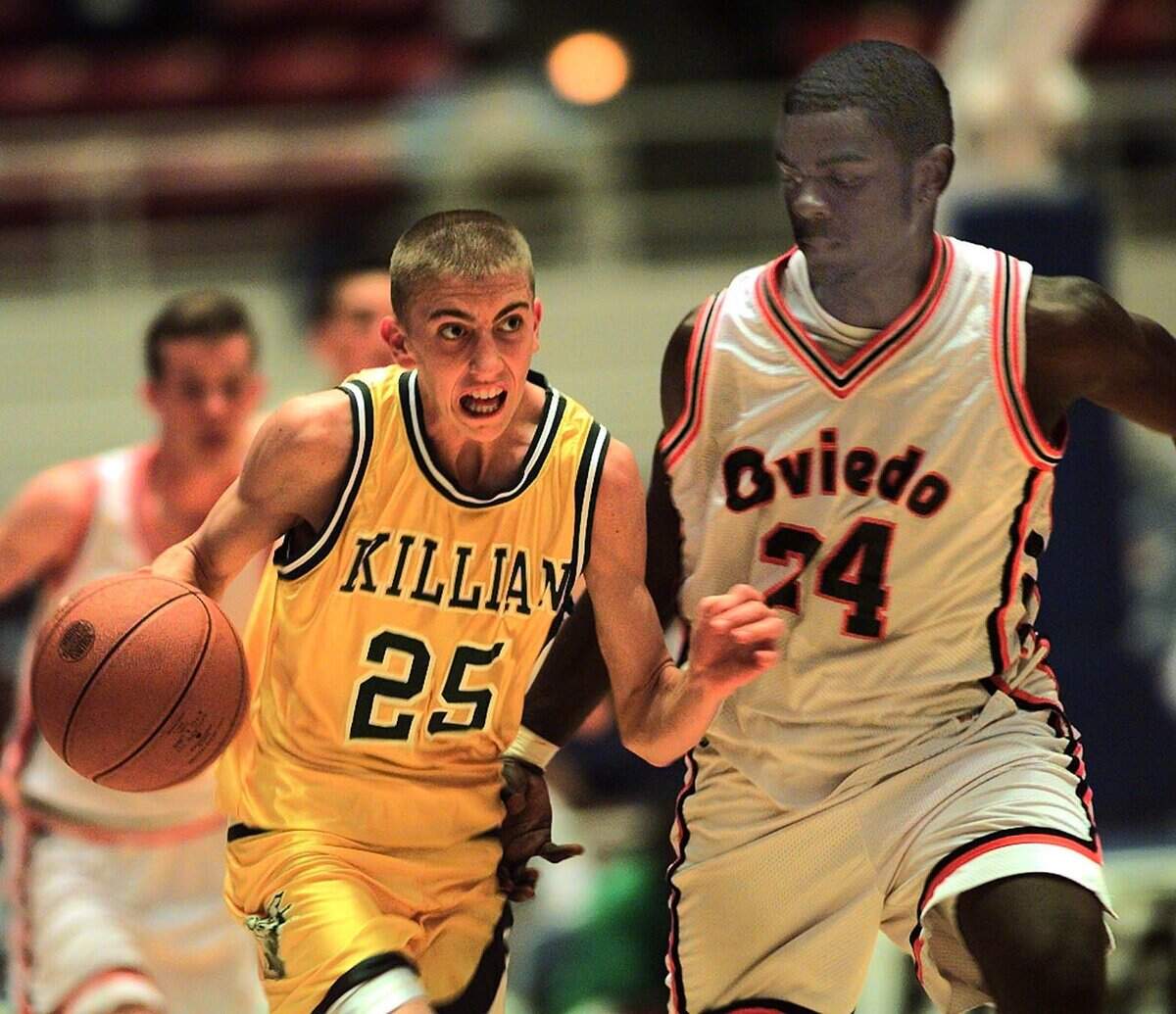 Pictured at the 1997 state basketball championship semifinal, Killian's Steve Blake brings the ball down court against OViedo's Aaron Thomas. Blake went on to play in the NBA for more than a decade.