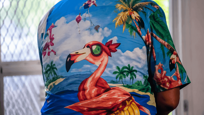 St. Lucie County deputies are searching for the “Flamingo Bandit,” accused of entering a home twice while wearing a tropical pink-flamingo shirt. This image was enhanced for clarity. (SLCSO)