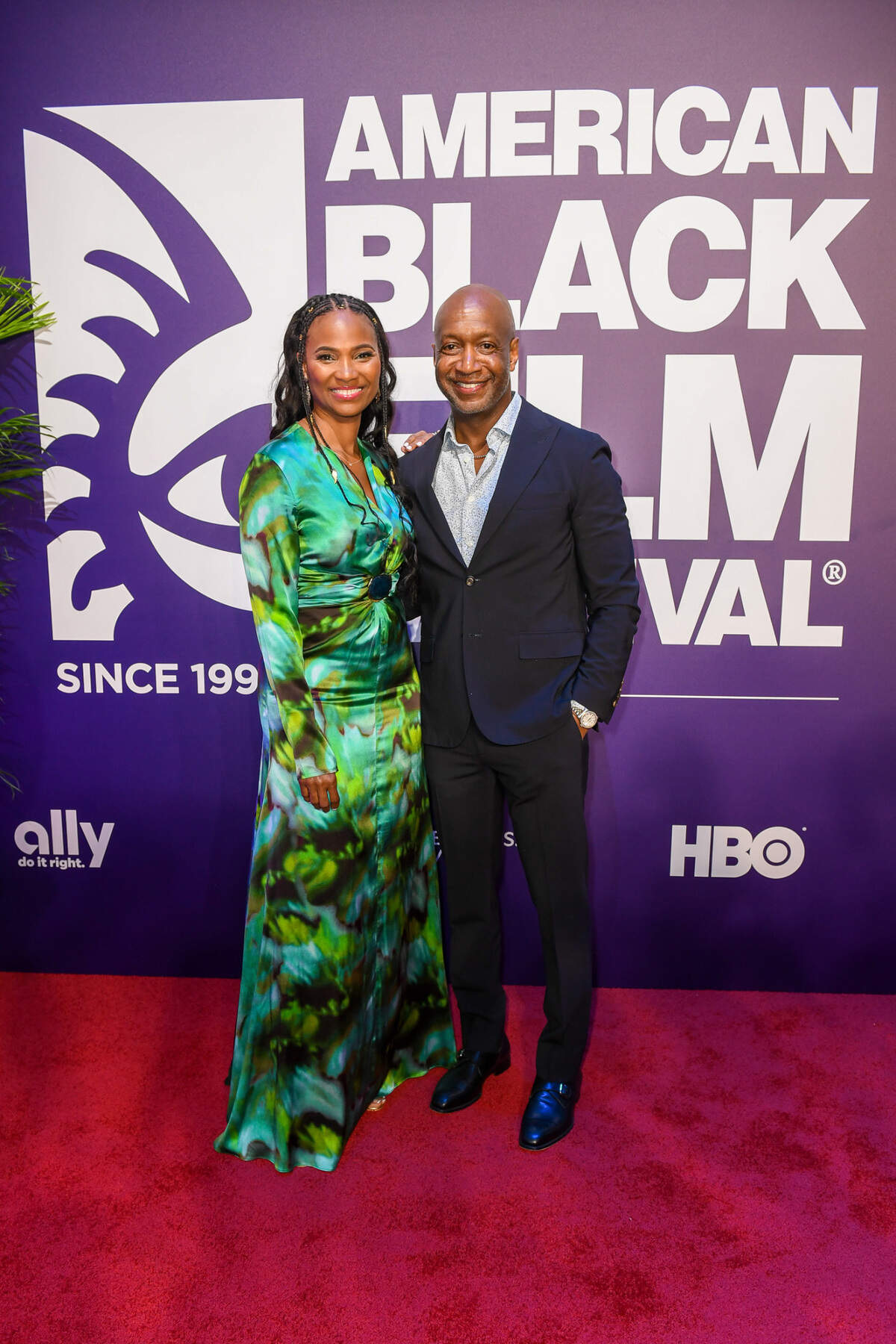 American Black Film Festival founder Jeff Friday and wife Nicole Friday pose on the red carpet for opening night of the festival.
