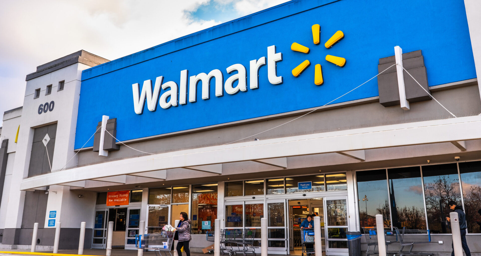 Walmart store entrance with the retailer’s blue facade and Walmart logo above the doors