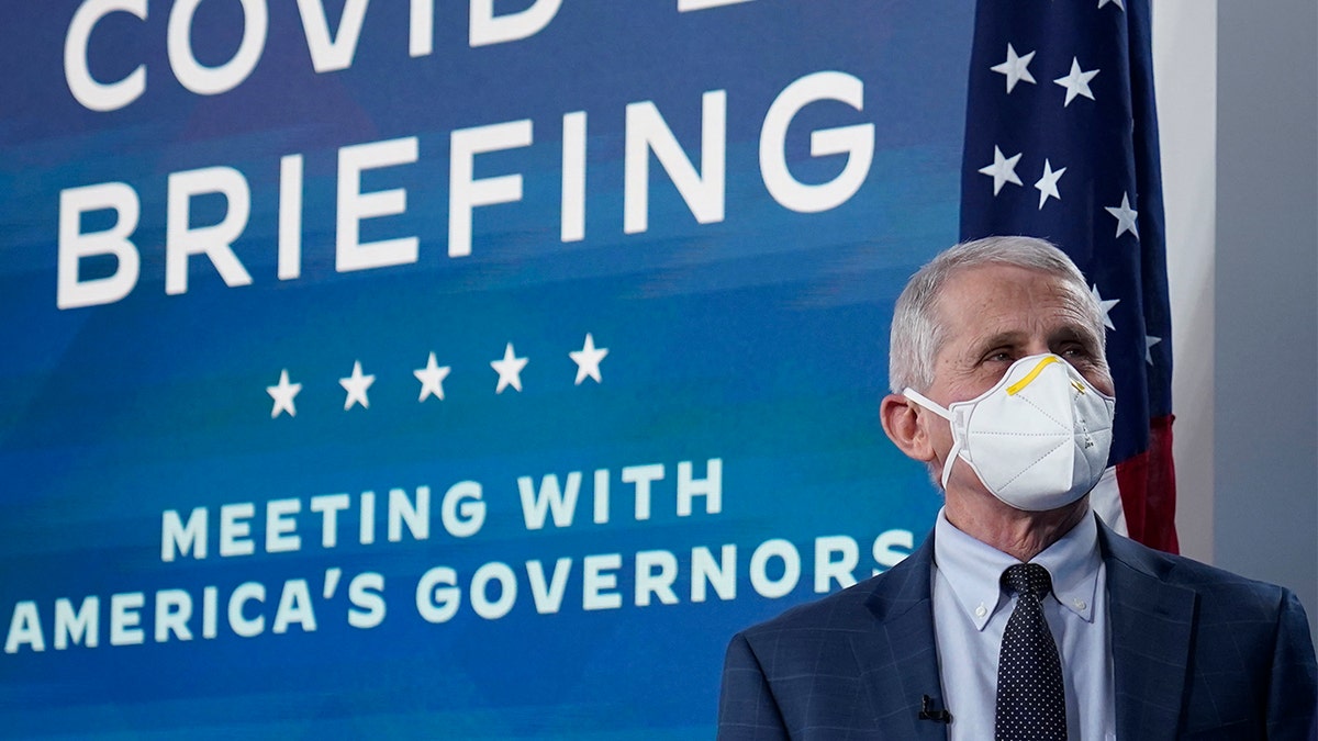 Dr. Anthony Fauci, the top U.S. infectious disease expert, wears a face mask as he arrives for the the White House COVID-19 Response Team's regular call with the National Governors Association in the South Court Auditorium in the Eisenhower Executive Office Building on the White House Campus, Monday, Dec. 27, 2021, in Washington. (AP Photo/Carolyn Kaster)