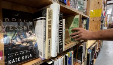 George Brooks shelves books at The Book Rescuers. (Spectrum News)
