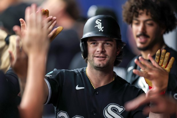 White Sox designated hitter Andrew Benintendi high-fives teammates in the dugout after hitting a solo home run against the Rays in the second inning Friday, July 31, 2026, in St. Petersburg, Fla. (Mike Carlson/Getty)