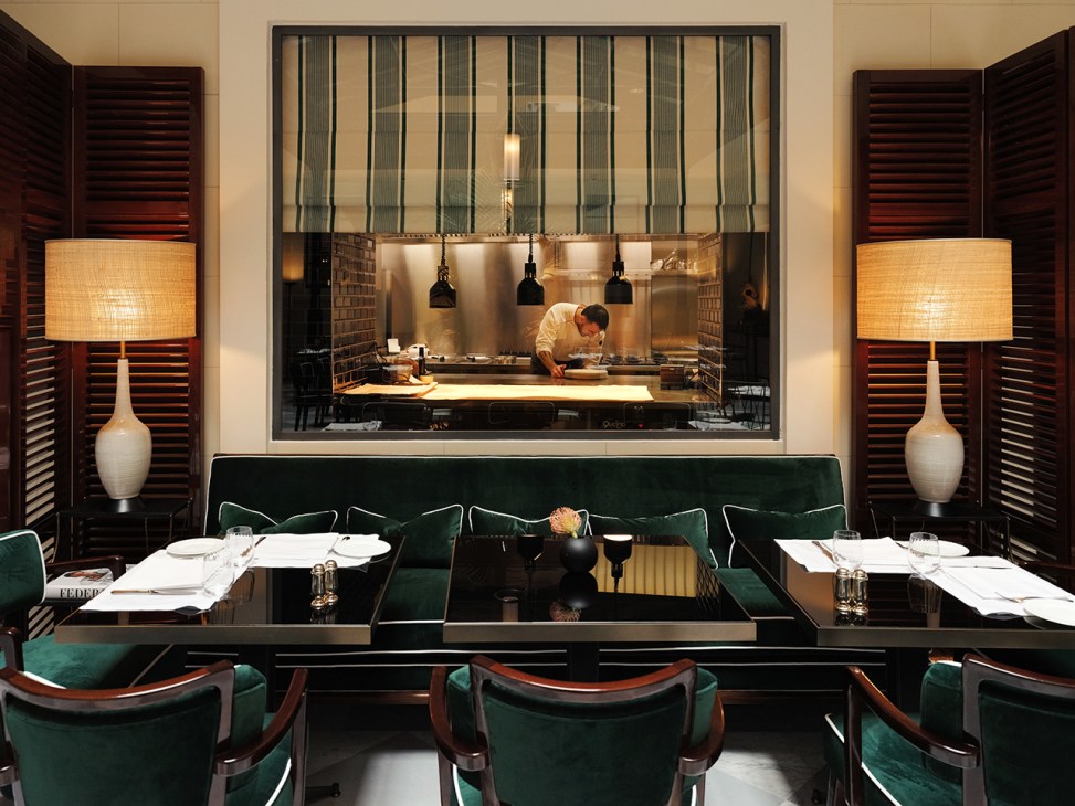 Chef working at the open kitchen counter of Casa JK Place's Al 22 Bistrot in Rome.