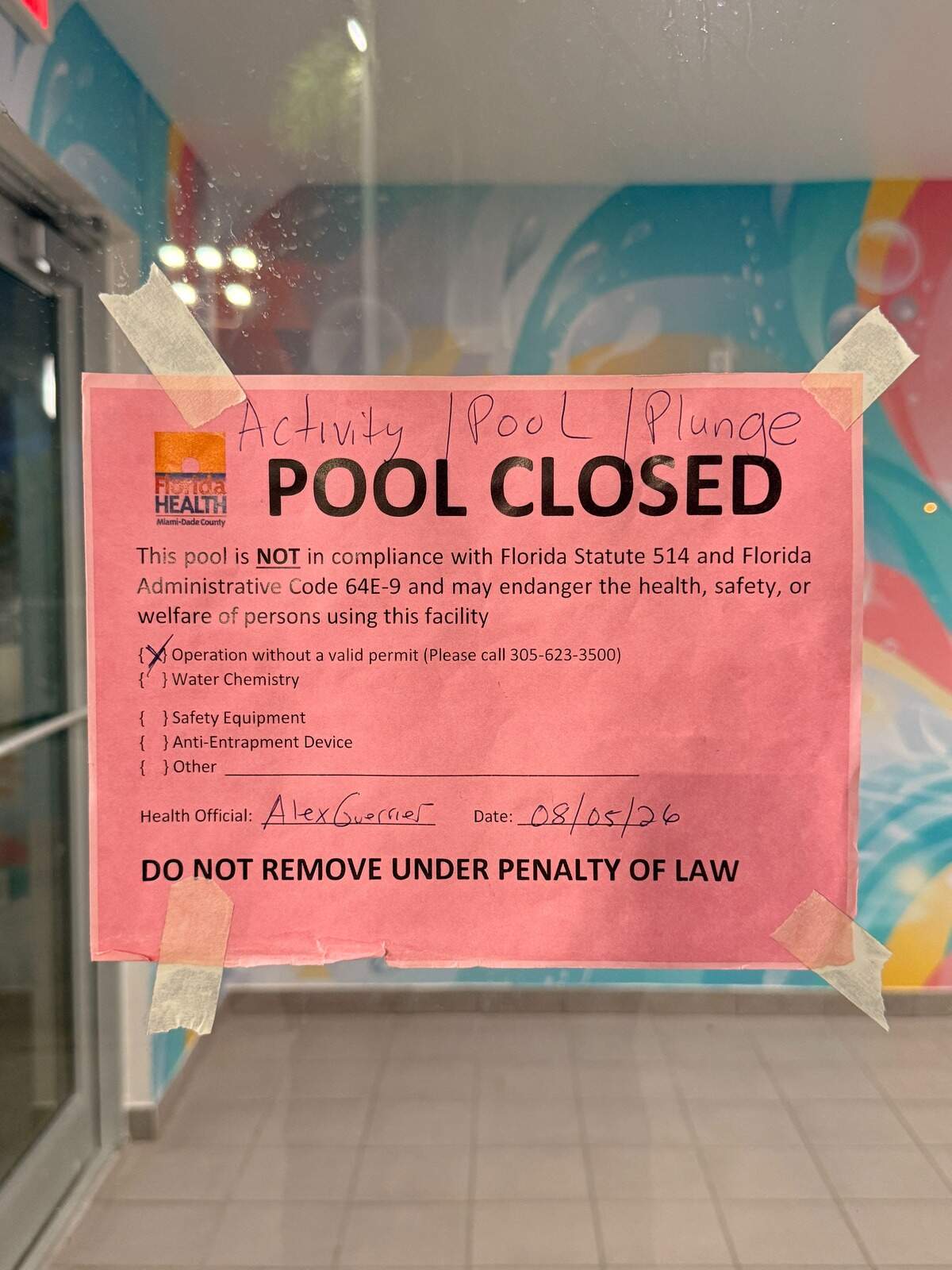 A Florida Department of Health closure notice posted at Bucky Dent Water Park after the agency ordered the city’s three swimming pools closed on Aug. 5.