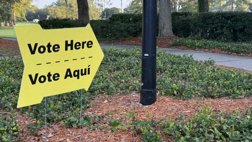 A "vote here" sign on election day, August 18, 2026.