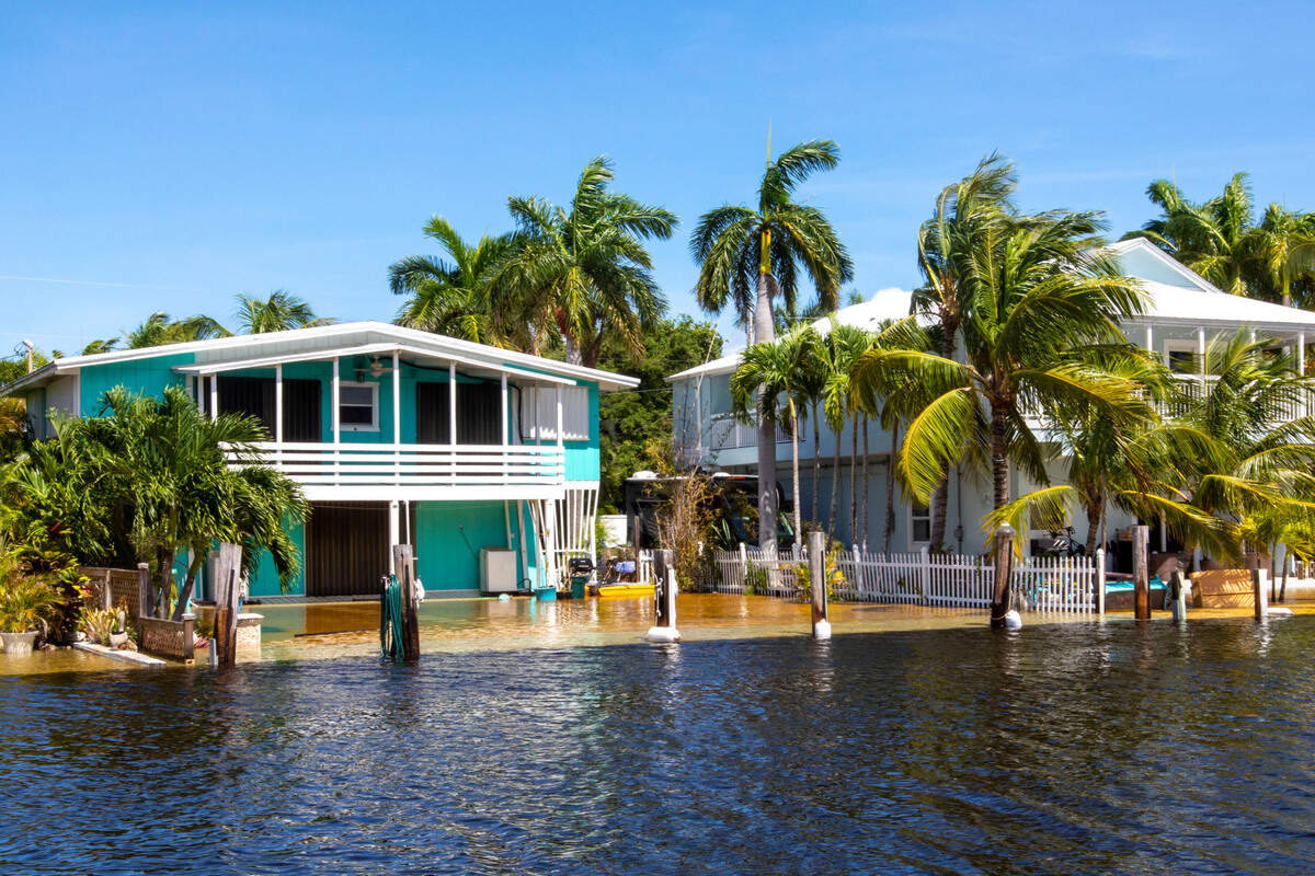 The back view of multiple Keys homes where the water in the canal nearly floods the backyards during flooding due to Hurricane Ian at Stillwright Point in Key Largo, Florida, on Thursday, September 29, 2022.