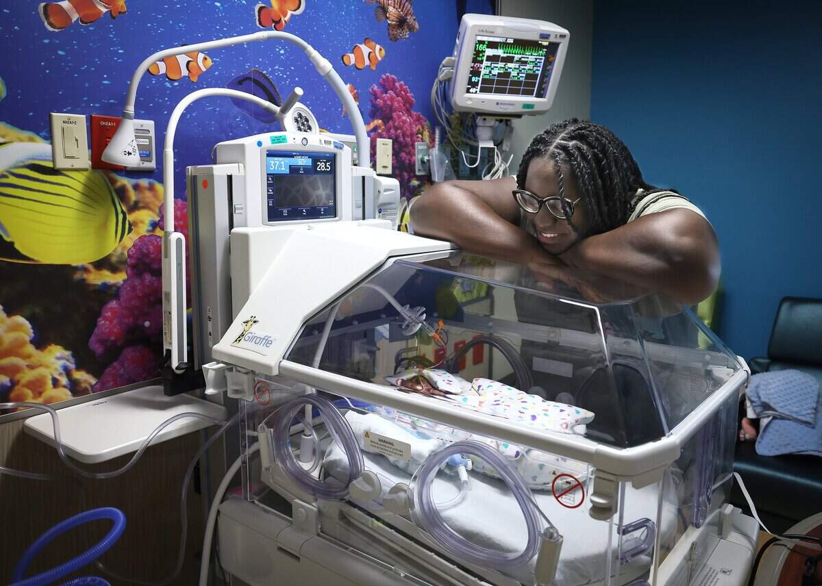 Hermione Petioma, right, smiles as she looks over her son, Hezekiah, who was born prematurely on Thursday, July 23, 2026, at Broward Health Medical Center's Labor and Delivery in Fort Lauderdale. The hospital is expanding pediatric services through a new partnership with Nicklaus Children's Health System, which now operates the pediatric hospital at Broward Health Medical Center. The initiative aims to create a countywide pediatric health network that will bring together experts from both Nicklaus and Joe DiMaggio Children's hospitals to provide care.