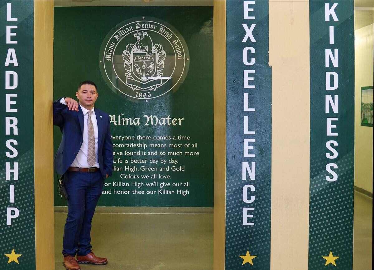 Miami Killian Senior High School Principal Jorge Parra is photographed at the entrance of the school on Monday, Aug. 24, 2026, in Miami. Killian has experienced the fastest-declining enrollment of any public school in Miami-Dade County, losing more than 80% of its students over the past 20 years.