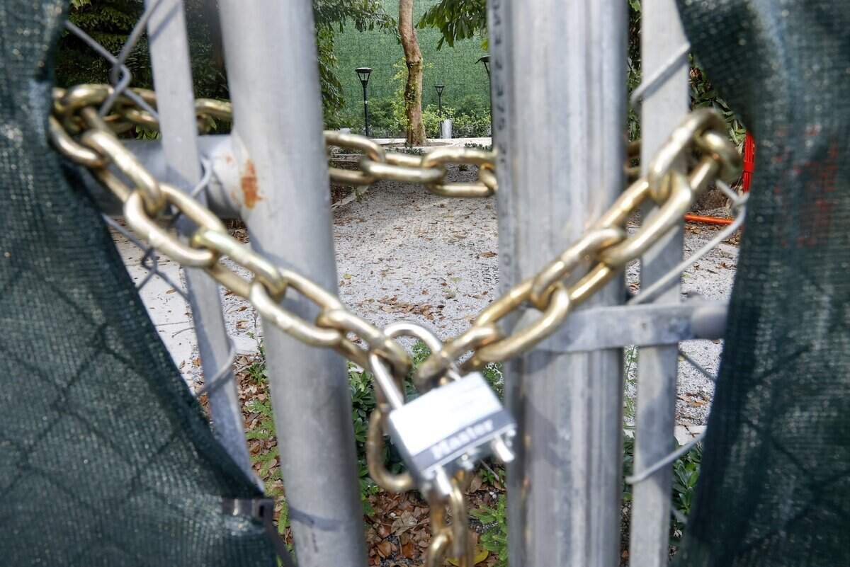Allen Morris Park, nestled between high-rise luxury condominiums in Miami's Brickell neighborhood, remains fenced and chained over the July 4 weekend in Miami, Florida on Tuesday, July 28, 2026.