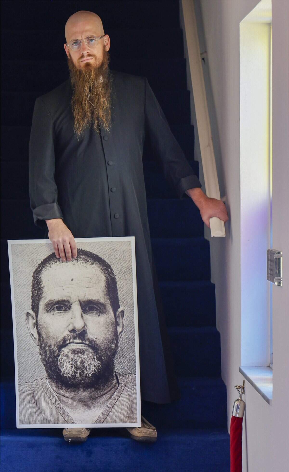 Rev. Jeff Hood, the spiritual advisor who has dedicated his pastoral career to counseling inmates on death row, holds a picture of William Silvia, who is set to be executed on August 18 after Sunday service at Sunshine Cathedral on August 17, 2026, in Fort Lauderdale, Florida. Hood, who has clients all over the country, has been busier than usual this year - particularly with inmates in Florida, a state that has reached record-breaking execution numbers under Gov. Ron DeSantis.