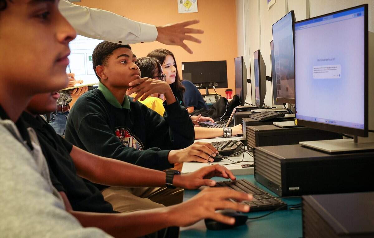 Miami Killian Senior High School teacher Mr. Michael Moreno (not seen) assists students with their a design project during a Digital Business Foundation class taught by Michael Moreno on Monday, Aug. 24, 2026, in Miami. Killian has experienced the fastest-declining enrollment of any public school in Miami-Dade County, losing more than 80% of its students over the past 20 years.