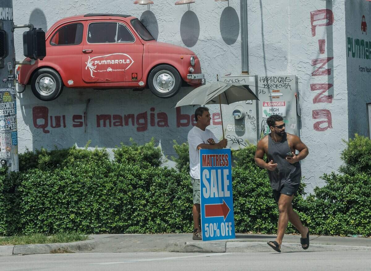 If you’re outside, take precautions against the heat. One man in Wynwood used an umbrella during a heat wave in July.