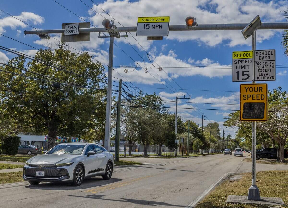 Cars drives by some school-zone speed limit signals that are part of the “School Zone Camera Safety Program” installed around the Palmetto Elementary, located at 12401 SW 74th Ave Pinecrest, on Wednesday, February 25, 2026.