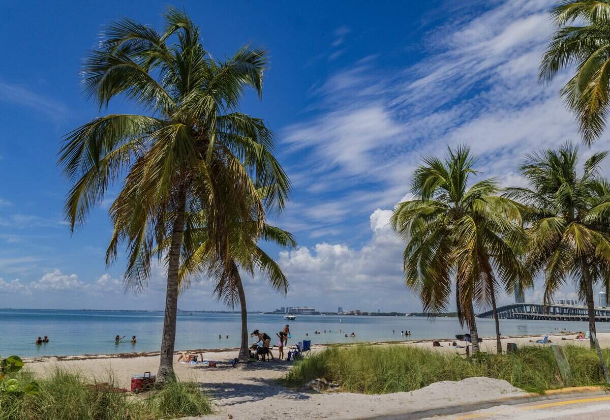 Beachgoers enjoy the nice weather at Hobie Island Beach as South Florida swelters under a heat advisory that warns of feels-like temperatures of 108, thoughts turn to the coming long Labor Day weekend in Miami , on Wednesday, August 27, 2025.